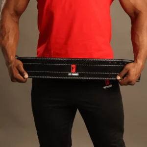 Atleta masculino sosteniendo con ambas manos un cinturón de fuerza profesional de cuero negro con costuras blancas reforzadas y logotipo central de Fit Fornes.