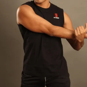 Hombre estirando el brazo usando una camiseta esqueleto deportiva negra sin mangas con el logo de Fit Fornes.